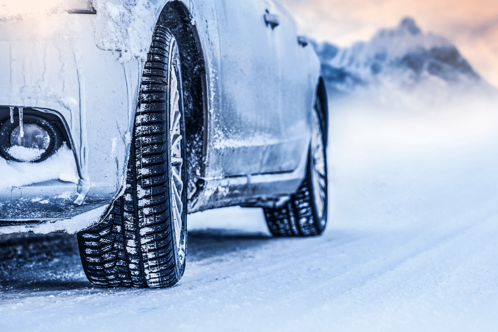 Tire service in Tea, SD by Sioux Empire Automotive Service Center. Close-up of winter tire tread gripping snowy road, highlighting traction and safety for South Dakota driving.