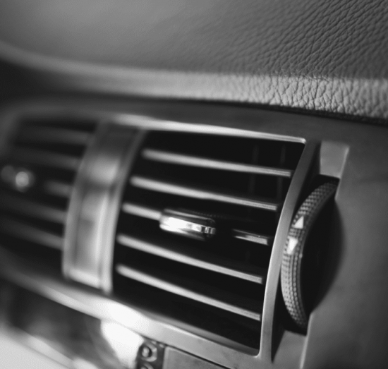 a/c repair, auto repair in Tea, SD at Sioux Empire Automotive Service Center. Black-and-white close-up of a vehicle’s A/C vent and directional knob, highlighting airflow direction and interior comfort control.
