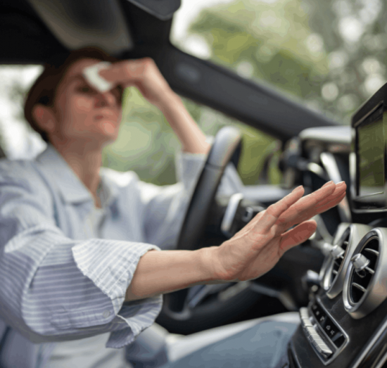 Auto a/c service, auto repair in Tea, SD, at Sioux Empire Automotive Service Center. Image of a driver struggling with hot cabin temperatures, highlighting the importance of professional auto A/C service to restore cooling performance and ensure a comfortable, reliable drive.